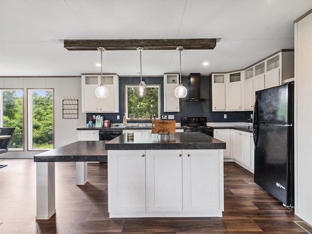 kitchen with black appliances, wall chimney range hood, dark countertops, healthy amount of natural light, and recessed lighting