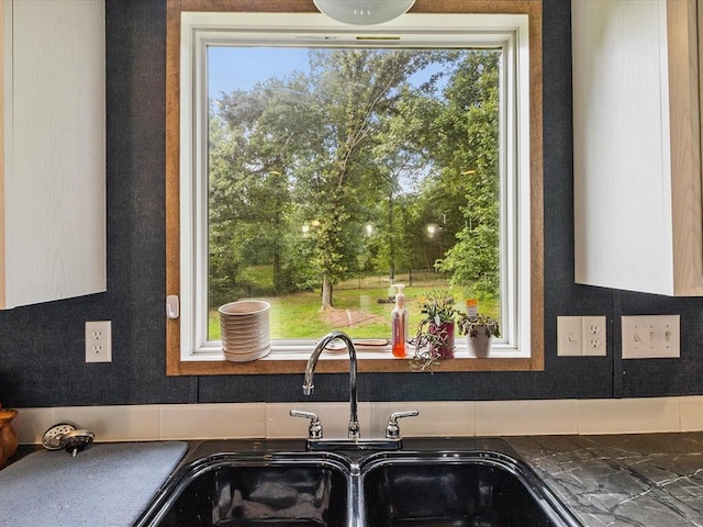 kitchen with dark countertops and healthy amount of natural light