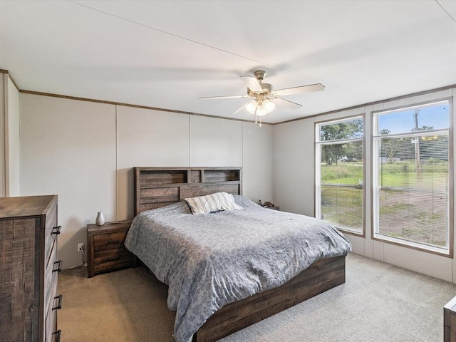 bedroom featuring light carpet and ceiling fan