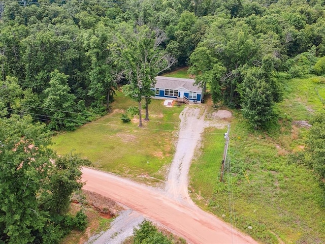 aerial view of property and surrounding area featuring a forest