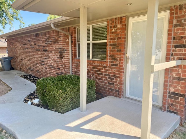 223 E Lincoln Ave, Edmond, OK 73034 - entrance to property with brick siding and covered porch