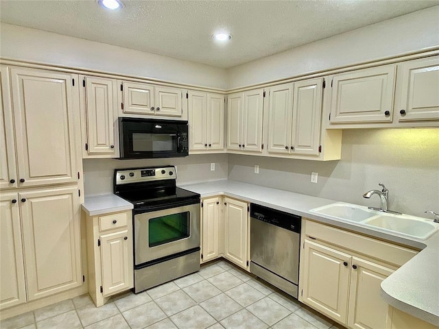 223 E Lincoln Ave, Edmond, OK 73034 - kitchen with appliances with stainless steel finishes, light countertops, light tile patterned floors, recessed lighting, and a textured ceiling