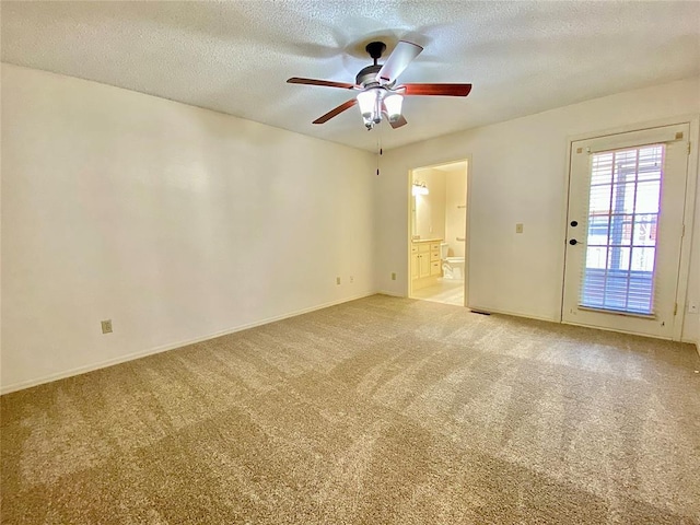 223 E Lincoln Ave, Edmond, OK 73034 - unfurnished room featuring carpet flooring, ceiling fan, and a textured ceiling