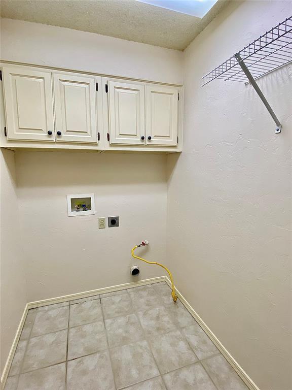 223 E Lincoln Ave, Edmond, OK 73034 - washroom featuring cabinet space, hookup for a washing machine, and gas dryer hookup