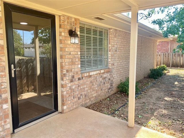 223 E Lincoln Ave, Edmond, OK 73034 - doorway to property with brick siding