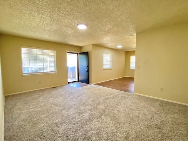 223 E Lincoln Ave, Edmond, OK 73034 - empty room with carpet floors and a textured ceiling