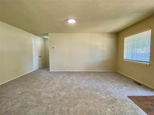 223 E Lincoln Ave, Edmond, OK 73034 - carpeted empty room with a textured ceiling