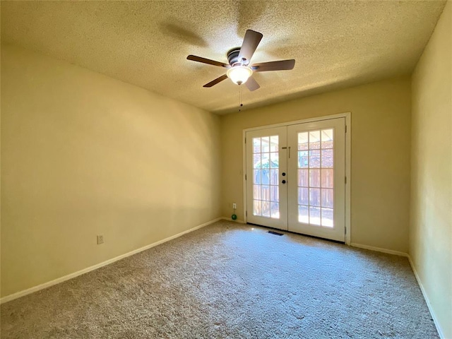 223 E Lincoln Ave, Edmond, OK 73034 - carpeted spare room with french doors, a textured ceiling, and ceiling fan