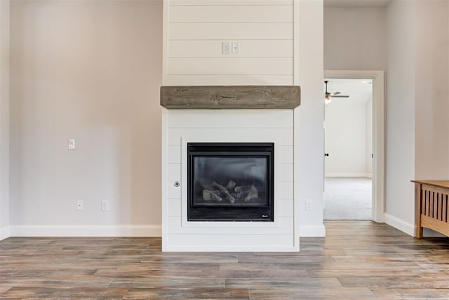 2408 NW 179th St, Edmond, OK 73012 - detailed view of wood finished floors, a glass covered fireplace, and ceiling fan