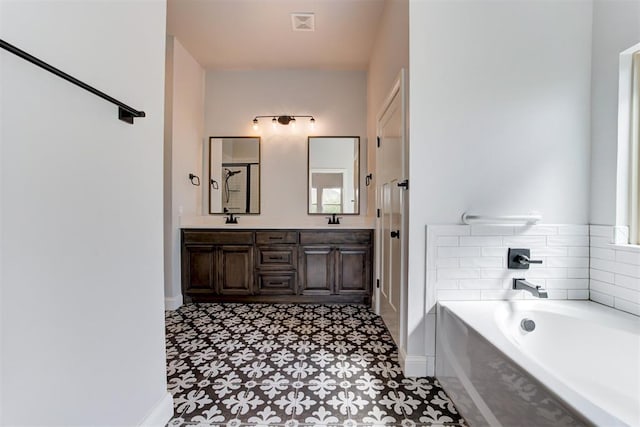 2408 NW 179th St, Edmond, OK 73012 - full bath featuring a garden tub, double vanity, and tile patterned floors