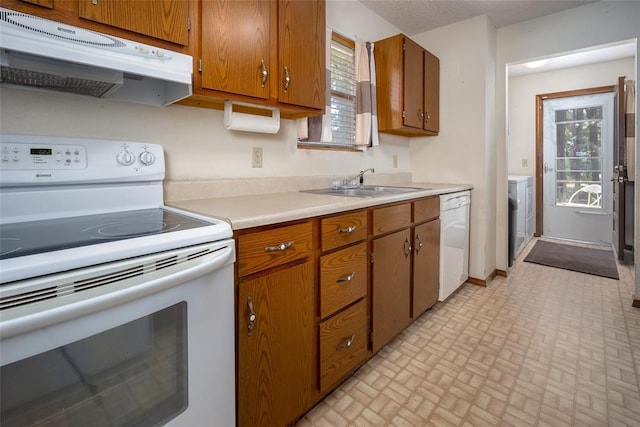 29877 Fishmarket Rd, Macomb, OK 74852 - kitchen with white appliances, under cabinet range hood, light countertops, brick patterned flooring, and brown cabinets