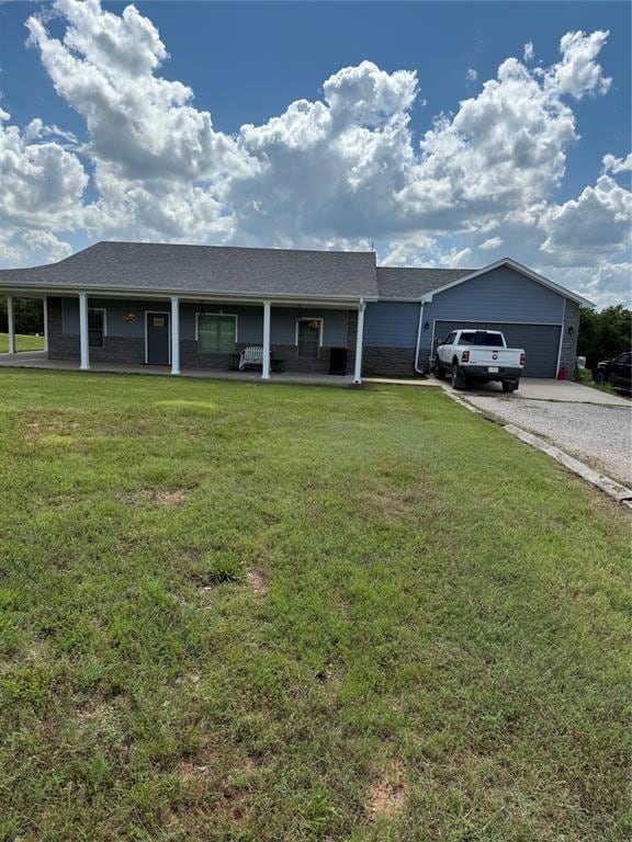 105967 S Rolling Hills Dr, Meeker, OK 74855 - single story home featuring covered porch, a front lawn, gravel driveway, and a garage