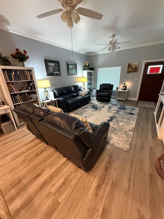 105967 S Rolling Hills Dr, Meeker, OK 74855 - living room featuring a ceiling fan, ornamental molding, and wood finished floors