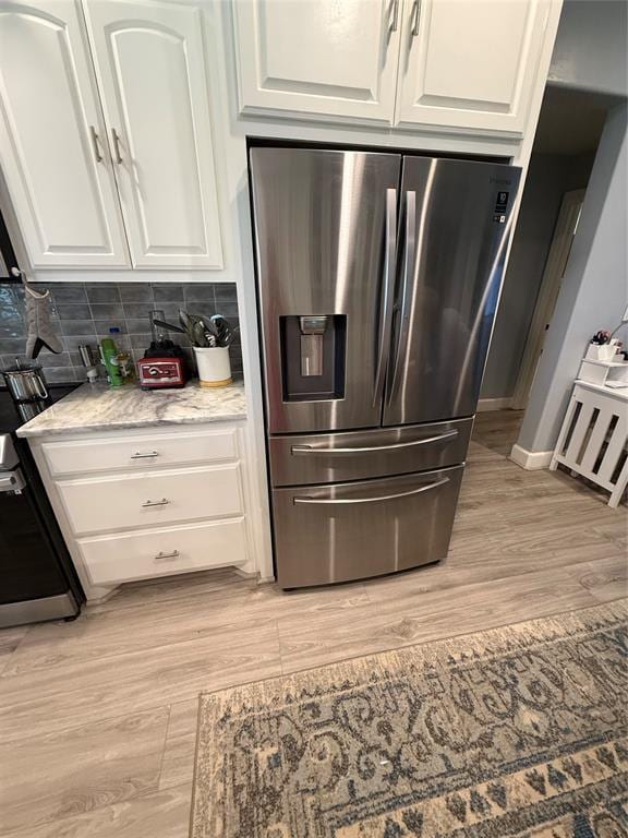 105967 S Rolling Hills Dr, Meeker, OK 74855 - kitchen with stainless steel fridge, white cabinetry, and light wood-style flooring