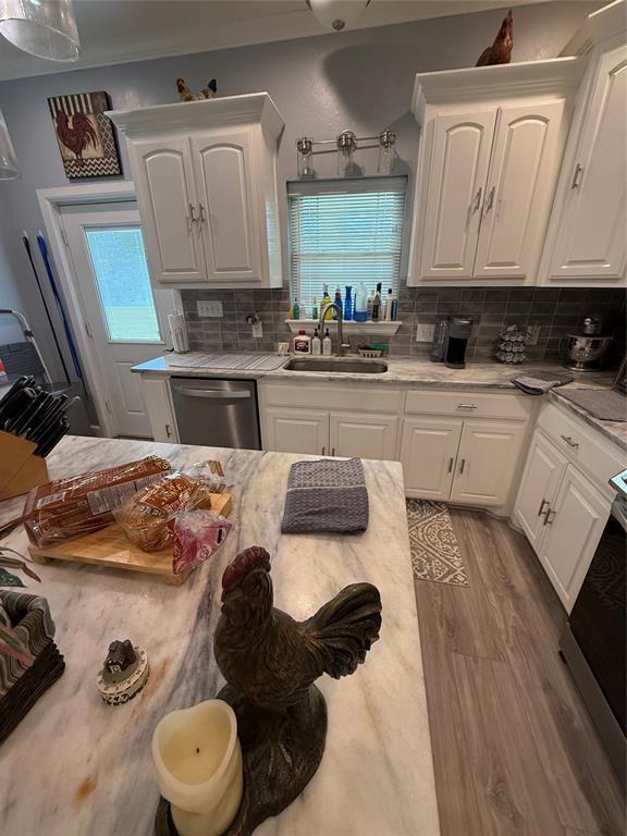 105967 S Rolling Hills Dr, Meeker, OK 74855 - kitchen featuring dishwasher, plenty of natural light, white cabinets, and backsplash