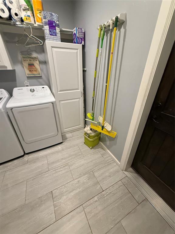 105967 S Rolling Hills Dr, Meeker, OK 74855 - washroom with independent washer and dryer, wood tiled floors, and cabinet space