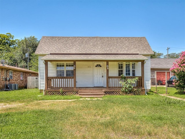 216 S 5th St, Noble, OK 73068 - bungalow-style home featuring covered porch, a front lawn, and roof with shingles