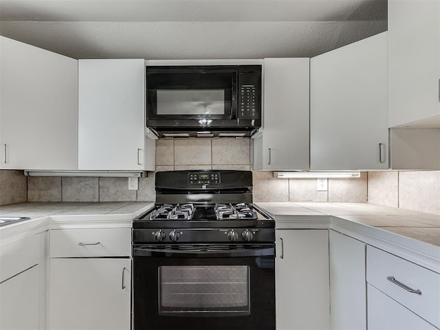 216 S 5th St, Noble, OK 73068 - kitchen featuring black appliances, light countertops, white cabinets, and tasteful backsplash