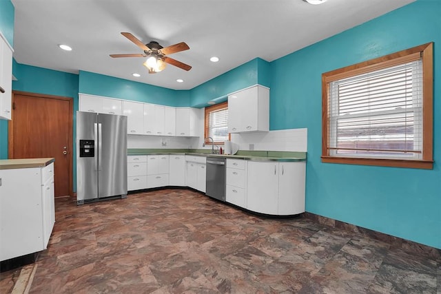 315 W 6th St, Cordell, OK 73632 - kitchen with appliances with stainless steel finishes, a ceiling fan, stone finish flooring, and white cabinets