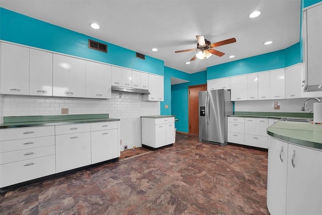 315 W 6th St, Cordell, OK 73632 - kitchen with stainless steel fridge with ice dispenser, a ceiling fan, tasteful backsplash, white cabinetry, and under cabinet range hood