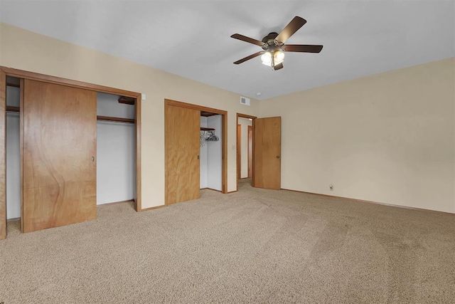 315 W 6th St, Cordell, OK 73632 - unfurnished bedroom with two closets, light colored carpet, and ceiling fan