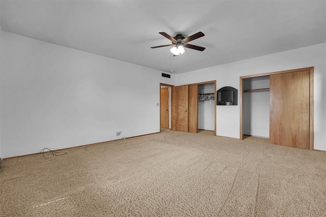 315 W 6th St, Cordell, OK 73632 - unfurnished bedroom featuring multiple closets, a ceiling fan, and carpet flooring