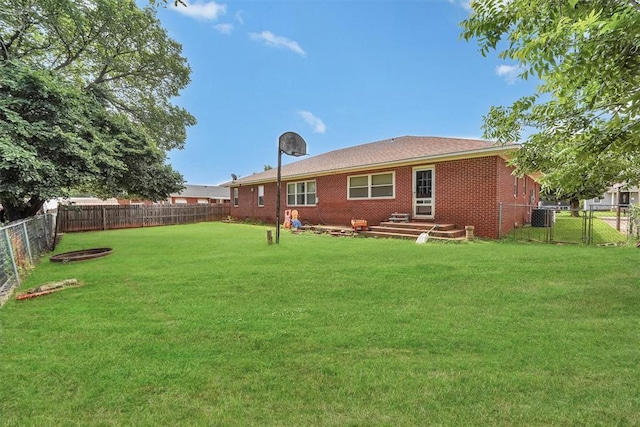 315 W 6th St, Cordell, OK 73632 - back of property featuring a fenced backyard, brick siding, and a gate