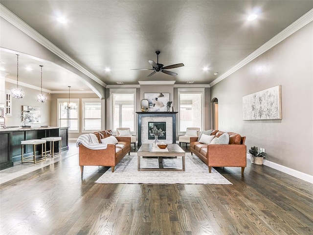 3009 Cordova Ct, Norman, OK 73072 - living area with plenty of natural light, arched walkways, wood finished floors, ceiling fan, and ornamental molding