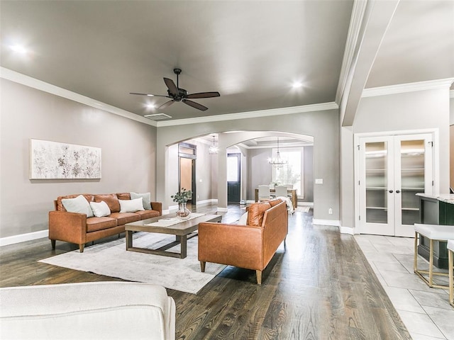 3009 Cordova Ct, Norman, OK 73072 - living room featuring arched walkways, a chandelier, ceiling fan, ornamental molding, and wood finished floors