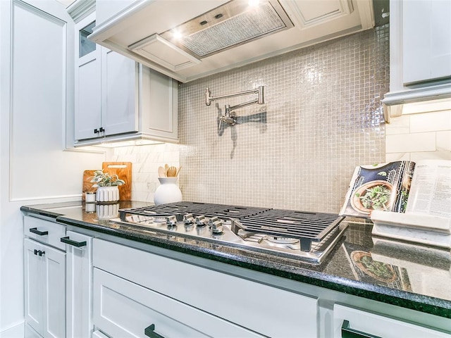 3009 Cordova Ct, Norman, OK 73072 - kitchen with stainless steel gas cooktop, backsplash, custom exhaust hood, and dark stone countertops