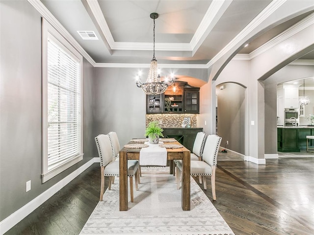 3009 Cordova Ct, Norman, OK 73072 - dining area featuring a chandelier, healthy amount of natural light, a tray ceiling, and crown molding