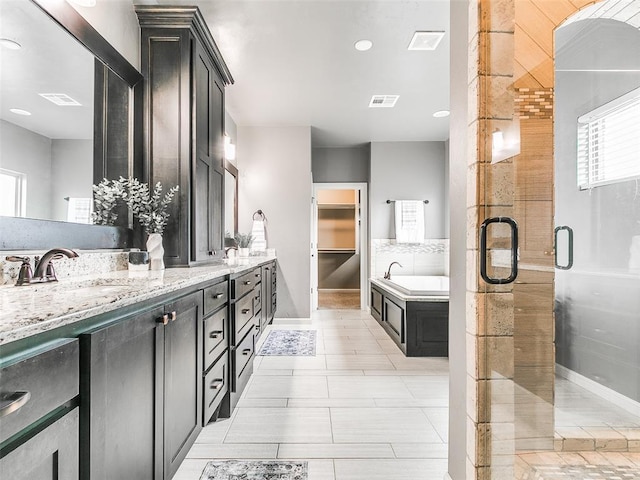 3009 Cordova Ct, Norman, OK 73072 - full bathroom with double vanity, a bath, a stall shower, and tile patterned flooring