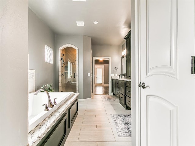 3009 Cordova Ct, Norman, OK 73072 - full bathroom with double vanity, a bath, tiled shower, and tile patterned flooring