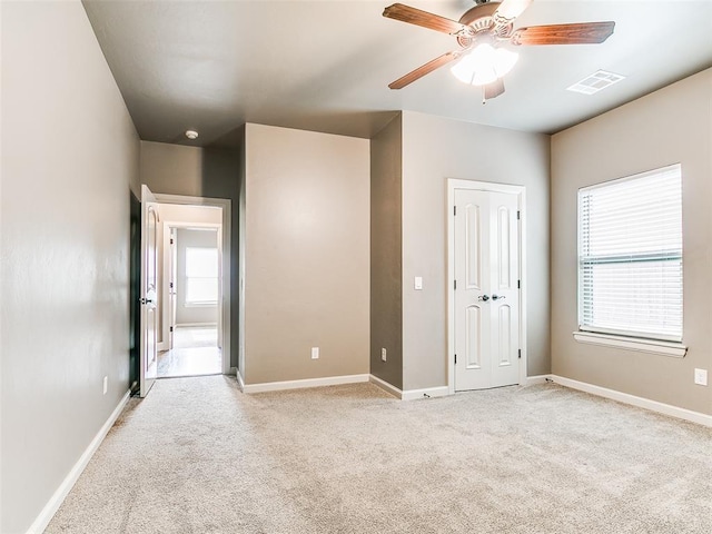 3009 Cordova Ct, Norman, OK 73072 - unfurnished bedroom with light colored carpet and a ceiling fan