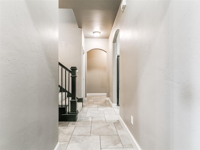 3009 Cordova Ct, Norman, OK 73072 - hallway with arched walkways, stairs, and a textured wall