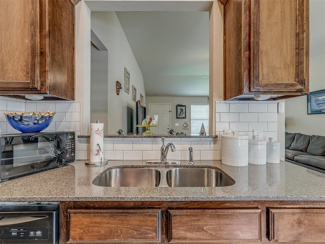 9505 SW 27th St, Oklahoma City, OK 73128 - kitchen featuring backsplash, stone counters, and brown cabinets