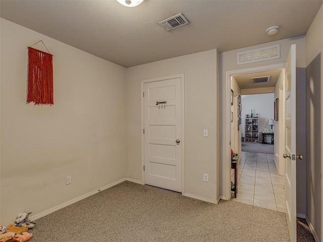 9505 SW 27th St, Oklahoma City, OK 73128 - empty room featuring light carpet, a smoke detector, and light tile patterned floors