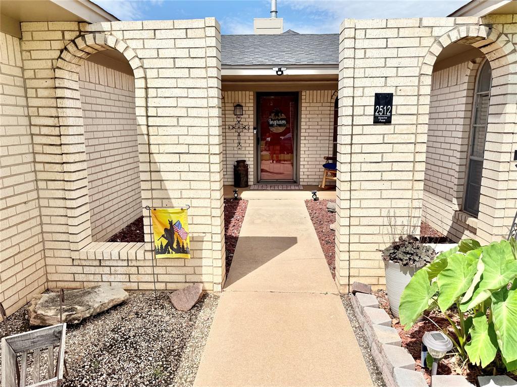 2512 Apache St, Altus, OK 73521 - doorway to property featuring a chimney and brick siding