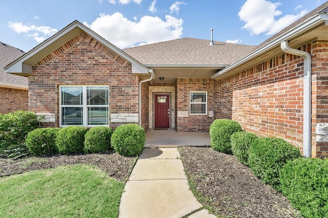 8309 NW 139th Ter, Oklahoma City, OK 73142 - doorway to property featuring brick siding and roof with shingles