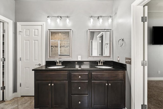 8309 NW 139th Ter, Oklahoma City, OK 73142 - bathroom featuring double vanity and baseboards
