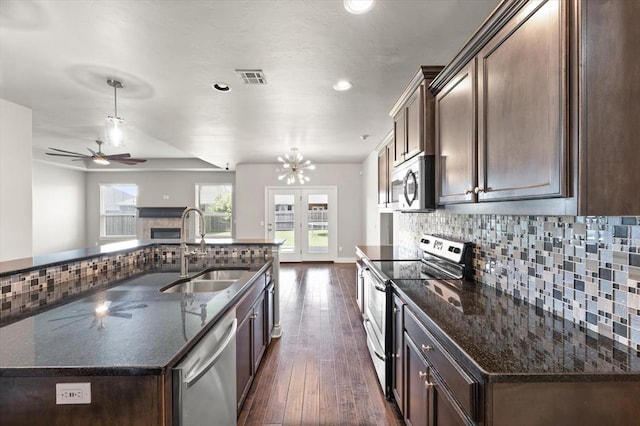 8309 NW 139th Ter, Oklahoma City, OK 73142 - kitchen with appliances with stainless steel finishes, decorative backsplash, dark wood finished floors, ceiling fan, and recessed lighting