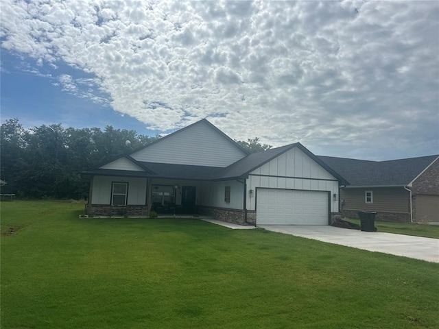 914 S Ash St, Luther, OK 73054 - view of front of home featuring a front lawn, board and batten siding, concrete driveway, and a garage