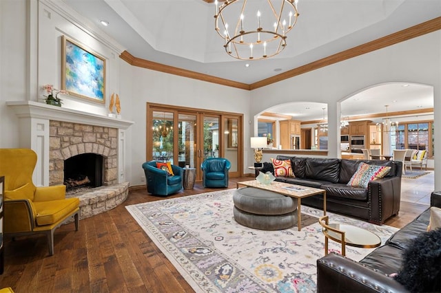 18816 Otter Creek Dr, Edmond, OK 73012 - living room with wood-type flooring, a chandelier, arched walkways, ornamental molding, and a towering ceiling