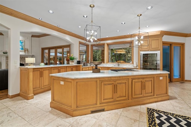 18816 Otter Creek Dr, Edmond, OK 73012 - kitchen with a chandelier, a spacious island, crown molding, recessed lighting, and decorative light fixtures