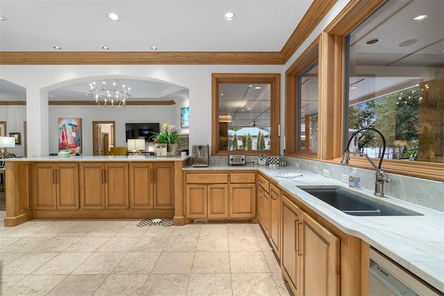 18816 Otter Creek Dr, Edmond, OK 73012 - kitchen featuring white dishwasher, crown molding, arched walkways, a peninsula, and a chandelier