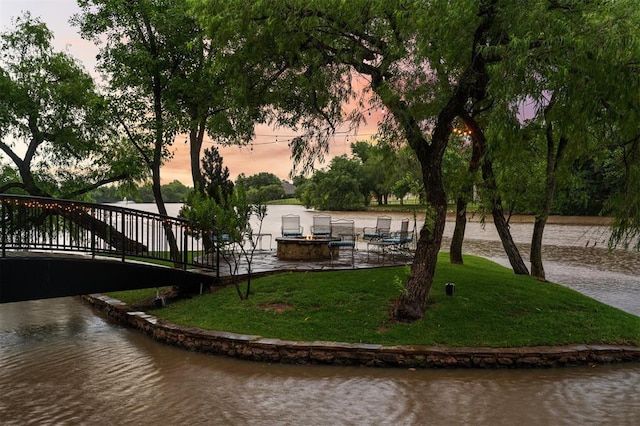 18816 Otter Creek Dr, Edmond, OK 73012 - exterior space with a fire pit, a water view, and a yard