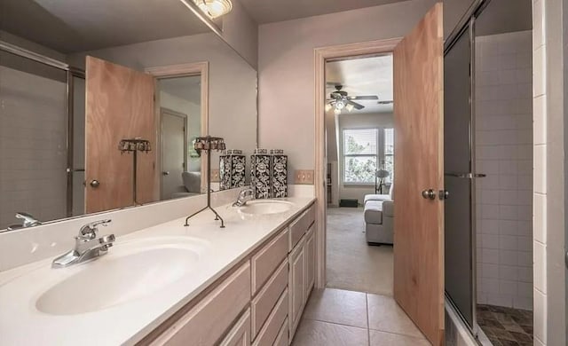 716 Fox Bend Trl, Edmond, OK 73034 - ensuite bathroom with ceiling fan, double vanity, a shower with door, and tile patterned floors