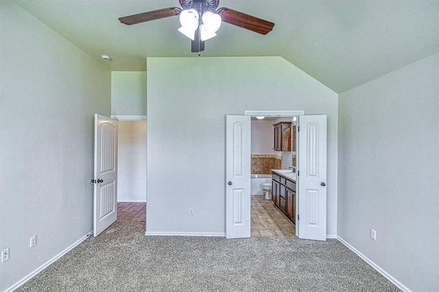 816 Lakeview Dr, Moore, OK 73160 - unfurnished bedroom with light carpet, vaulted ceiling, connected bathroom, and ceiling fan