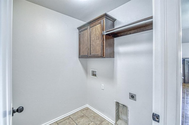 816 Lakeview Dr, Moore, OK 73160 - laundry room featuring electric dryer hookup, washer hookup, cabinet space, and light tile patterned flooring