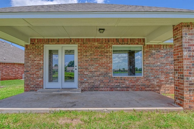 816 Lakeview Dr, Moore, OK 73160 - view of exterior entry featuring a patio, brick siding, and french doors